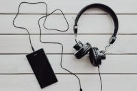Kaboompics - Black smartphone and headphones with various items
