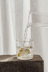 Kaboompics - Lemon slice in a glass of water - pouring