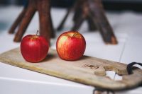 Red apples on a wooden board