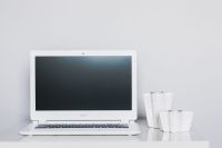 White laptop with candles