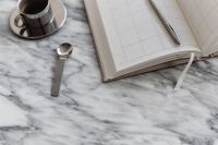 Kaboompics - Coffee in a steel cup - Calendar - Arabescato marble - Metal spoon