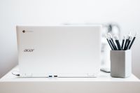 White laptop with pencils