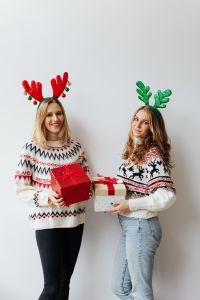 Kaboompics - Women with Christmas Gift wearing sweater and reindeer horns on head