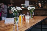 Table with white flowers in glasses