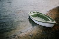 Little green boat by the shore
