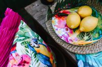 Lemons on colorful plate, tropical pillows