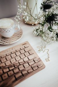 Wooden keyboard, coffee and flowers