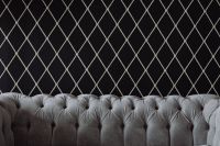 Elegant grey sofa by the wall
