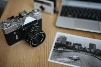 Old Zenit camera with a laptop and a black-and-white photo
