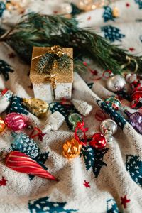 Christmas gift and colourful tree decorations on a blanket