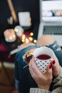Woman drinking hot tea in her home office