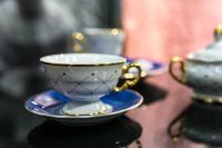 White and blue teacups with saucers
