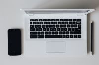 White laptop with smartphone