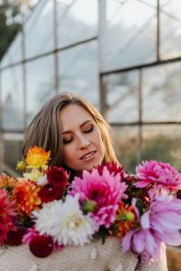 Kaboompics - A woman with beautiful colorful dahlia flowers
