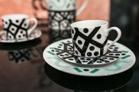 Black-and-white teacups with saucers