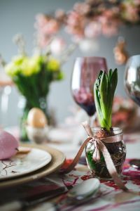 Easter table with cute pink decorations, flowers, catkins and eggs
