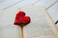 Little red heart with an old book