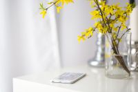 Kaboompics - White smartphone with yellow flowers