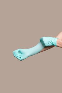 Kaboompics - Woman hands putting on a latex gloves
