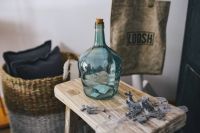 Cyan decorational bottle on a wooden stool