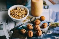 Walnuts with a fresh healthy shake and musli in a bowl