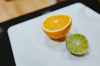 Orange and a lime on a cutting board