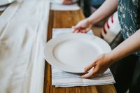 Woman putting a plate on a table