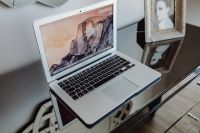 Silver Apple MacBook Pro on a shiny table