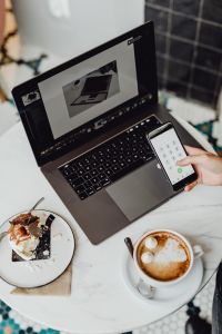 Kaboompics - Working with a laptop & iPhone X, meringue with whipped cream and coffee on white marble