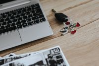 Black-and-white photos with a silver laptop and car keys