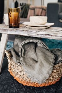 Glass, wooden bowls, bench, basket, blanket