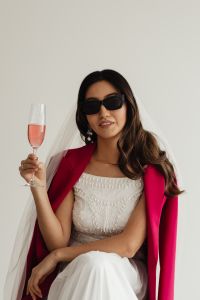 Kaboompics - Wedding - Bride - Portrait - Veil - Glass of Champagne - Sunglasses - Pink Jacket