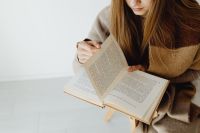Kaboompics - A young girl reads a book