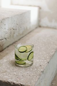 Water glass - cucumber - ice cubes - concrete stairs