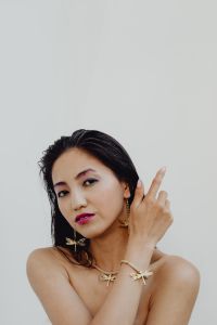 Beautiful Asian woman wears massive gold handmade jewelry