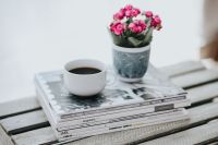 Kaboompics - Little pink flowers with a coffee and a stack of magazines