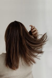 The back of a young woman - medium-length brown straight hair