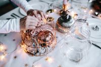 Kaboompics - Hands Decorating Christmas Table