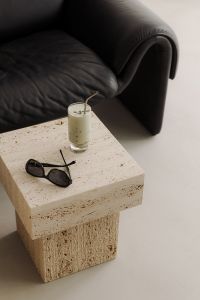 Matcha Latte on Travertine Table Next to Black Leather Sofa - Japandi Style