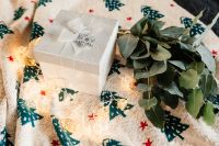Kaboompics - White decorative gift box and eucalyptus twigs on a blanket