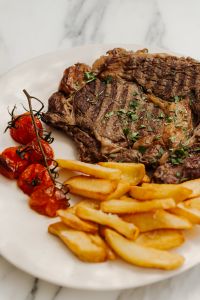 Kaboompics - Gourmet Plate with Steak - Fries - Dip - Grilled Tomatoes