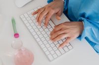 Female scientist - computer keyboard - work - desk