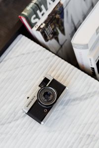 Kaboompics - Old camera on marble - top view