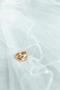Golden rings on a white veil
