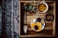 Kaboompics - Room service tray at hotel for breakfast: cookies, jam, chocolate mousse, orange fruit, tea