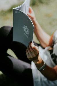 Kaboompics - Woman reading a magazine outdoors