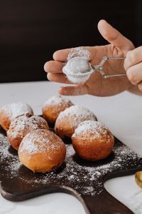 Homemade Polish doughnuts with cherry filling, covered with powdered sugar. Traditional speciality on Fat Thursday in Poland.