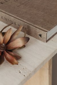 The book lies on a travertine table - Kinfolk - dried flower