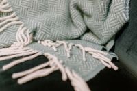 Kaboompics - Pastel green blanket on a velour dark green armchair