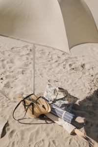 Kaboompics - Beach Umbrella and Bag on Sandy Shore